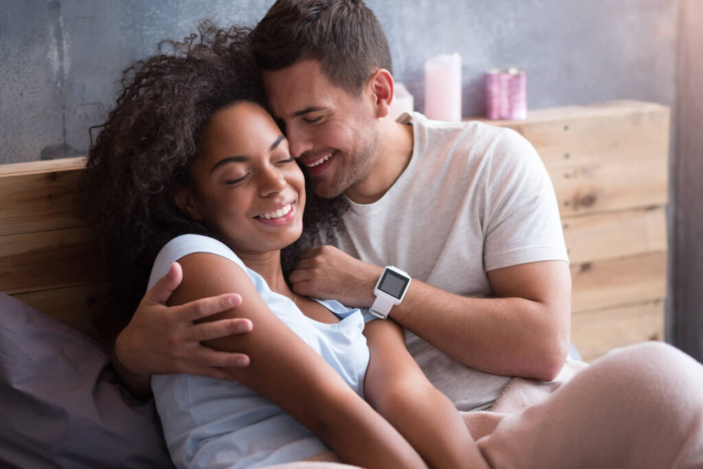 Couple hugging each other in bed